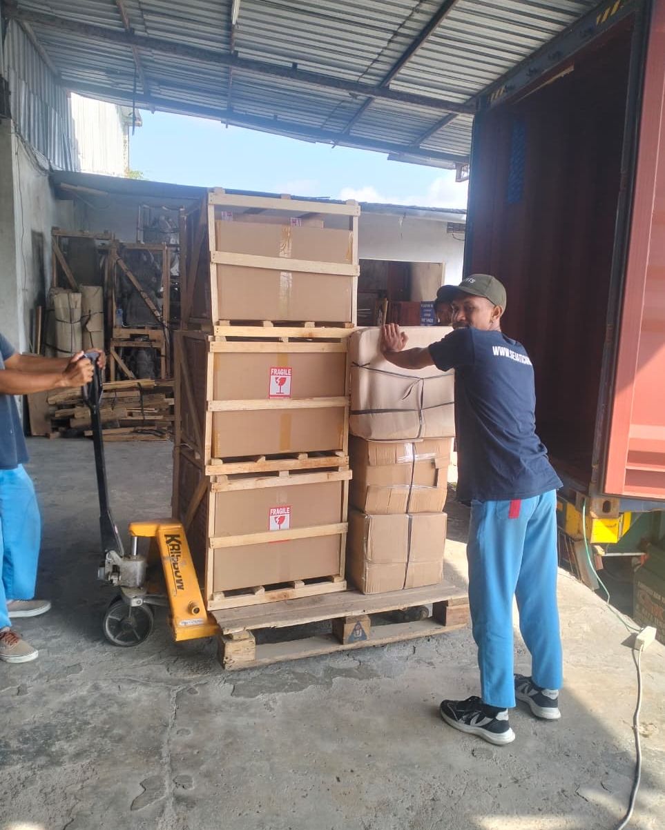 Cartons moved by pallet jack in the warehouse